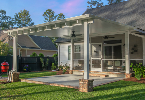 Covered patio with ceiling fans and a spacious backyard area